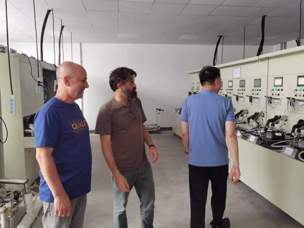 OEM & ODM SERVICE 22 European buyers inspect vacuum cleaner testing equipment in our factory, discussing OEM ODM private label bulk cooperation plan