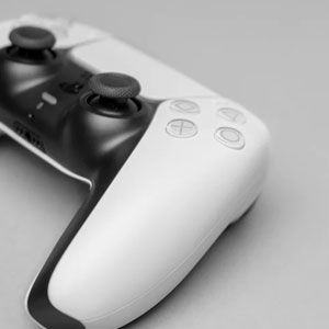 Close-up of a modern gaming controller with black and white design.
